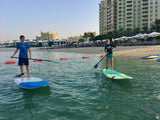 Boys Stand Up Paddling on the sea